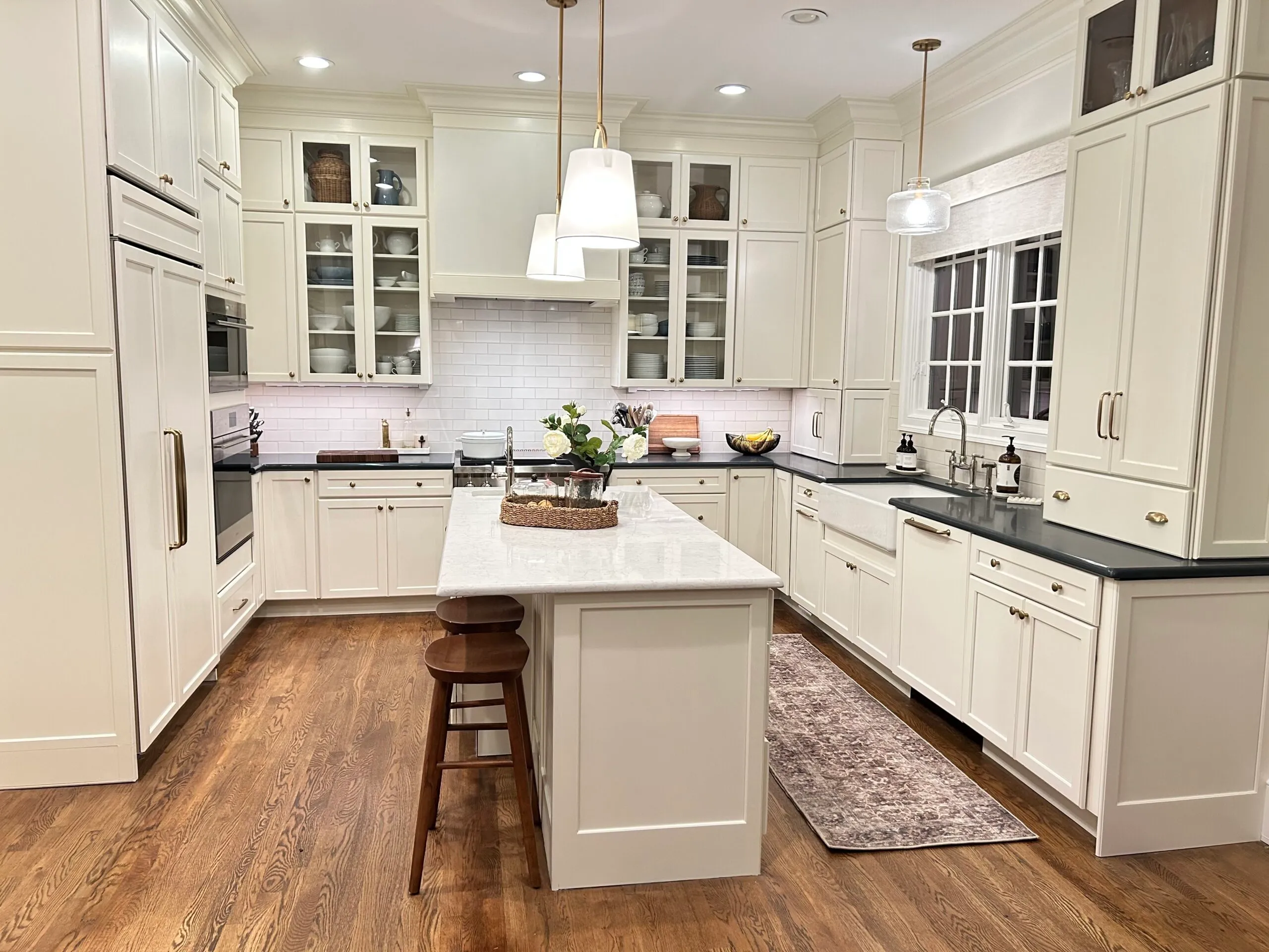 Bright white kitchen remodel with a large island and wood floors