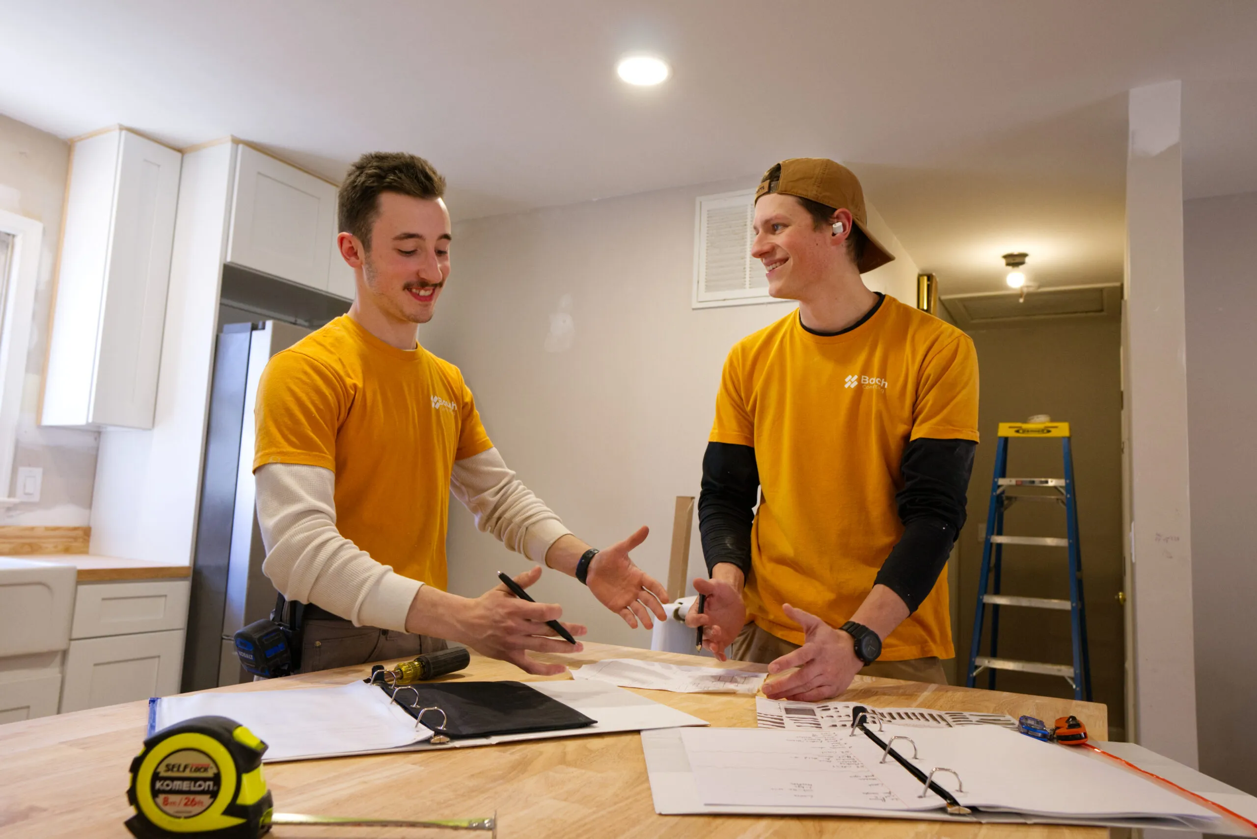 Reviewing plans on a kitchen island